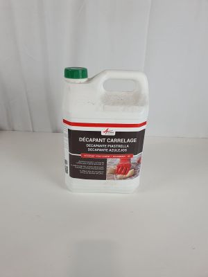 a white bottle of cleaner sitting on top of a white table