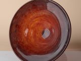 a brown bowl sitting on top of a white table
