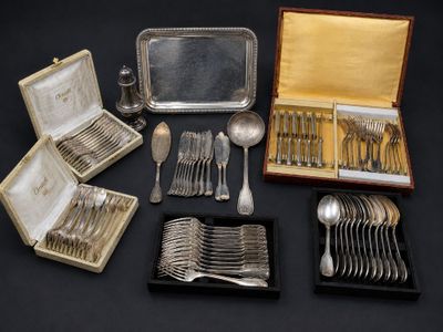 an assortment of silverware including spoons, forks, and a tray