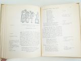 a person holding an open book with a drawing on it