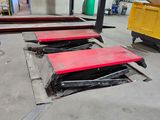 several pieces of metal sit on the floor in a warehouse