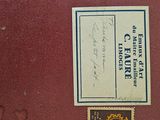 a red book with a black and white label on it