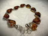 bracelet made of glass beads and silver wire on a white surface