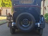 a vintage car parked on the side of the road