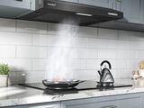 a picture of a kitchen with a stove and a tea kettle