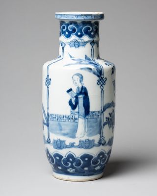 a blue and white vase with a picture of a man on it