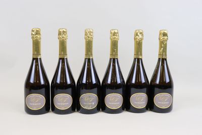 six bottles of champagne are lined up in a row