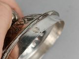 a person holding a silver ring in their hand