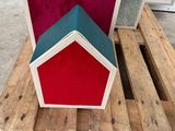 a wooden pallet with a red and blue house on it