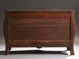 an old wooden chest sitting on top of a white floor