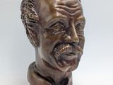 bronze bust of a man with a beard and a mustache