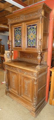 a wooden cabinet with stained glass windows in a room