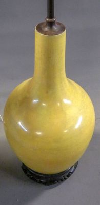a yellow vase that is sitting on a table
