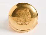 an image of a gold locke with a woman ' s face engraved on it