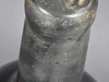 a close up of a wine bottle with a metal cap