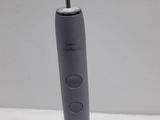 an electric toothbrush sitting on top of a white table