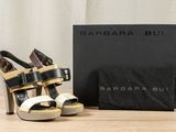 a pair of shoes sitting on a table next to a box