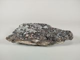 a close up of a piece of rock on a white surface