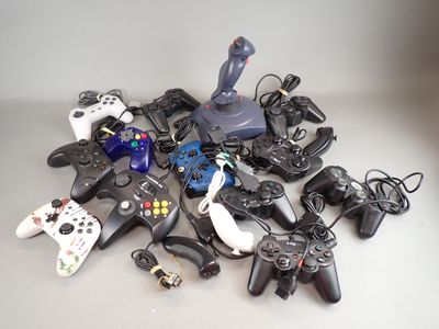 a pile of video game controllers and controllers on a table