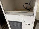 a small refrigerator that is sitting on the floor