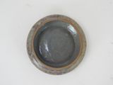 a small bowl with a brown rim on a white surface