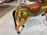 a wooden horse that is on display in a room