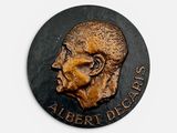 the head of a man with a beard is shown on a plaque