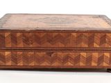 a small wooden box with a pattern on it