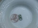 a white plate with a stamp on it sitting on a table