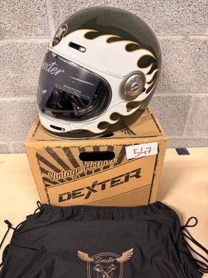 a helmet and a bag on a table next to a brick wall