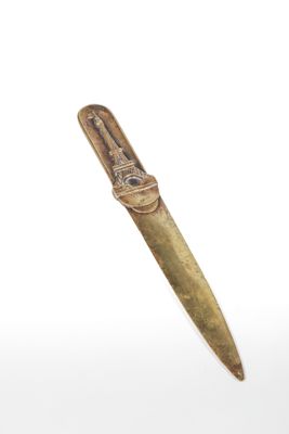 an image of a knife with a gold handle on a white background