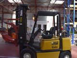 a yellow fork truck parked inside of a building