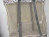 a mesh bag hanging on a wall with a handle