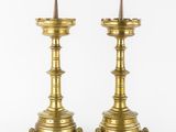 a pair of brass candlesticks with spikes on each of them