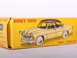 a box of dinky toys on a white surface