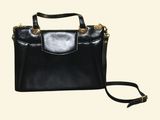 a black leather handbag with gold hardware on the handle