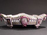 an ornately decorated bowl with a pink and white design