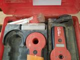a red tool box with tools in it on a table