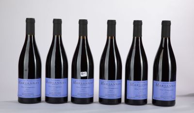 six bottles of wine are lined up in a row on a table