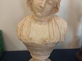 a statue of a woman that is sitting on a table