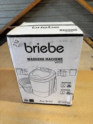 box of briebe washing machine sitting on a table in a room