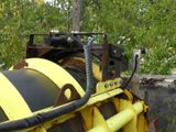 a large yellow machine that is sitting in the grass