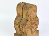 a small wooden clock that is sitting on a white surface