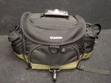 a camera bag that is sitting on the ground