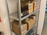 a metal shelf with bottles and boxes on top of it