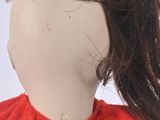 a doll with a red shirt and a brown scarf on it