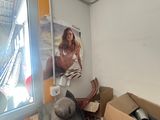 a woman that is standing in a room with many boxes