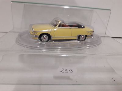 a yellow toy car in a clear display case