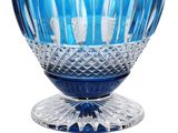 a blue glass vase with a blue base on a white background