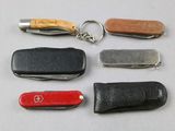 four different types of swiss army knives and a keychain